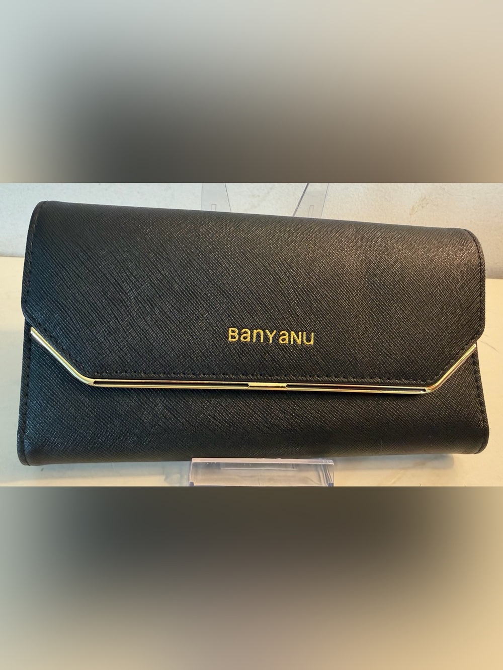 Banyanu RFID black leather wallet with gold-tone trim along the flap.